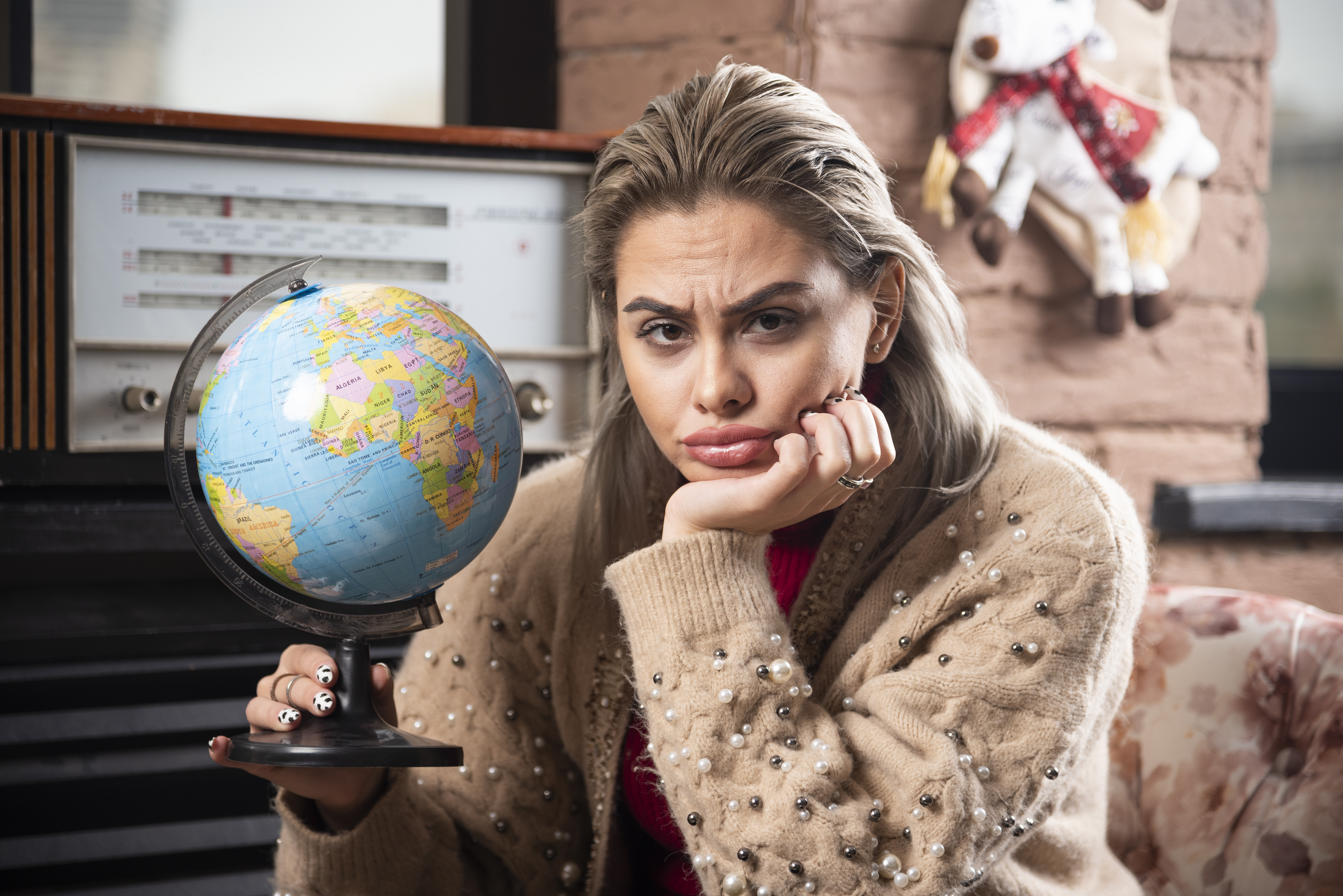 Portrait of beautiful lady holding a world globe